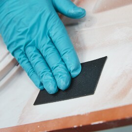 Applying repair patch to rear side of the damaged bumper