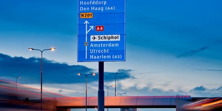 Reflective overhead road signs on busy highway
