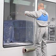 Man positioning the dirt trap protectin film on a window