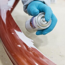 Coating tab area with adhesion promoter