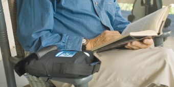 Man sitting in chair with ACTIV.A.C.™ Therapy Unit
