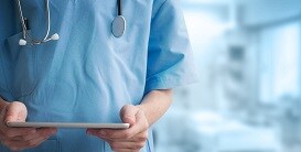 Physician looking at a tablet
