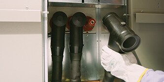 A worker is using 3M™ Cold Shrink technology for medium voltage separable connectors
