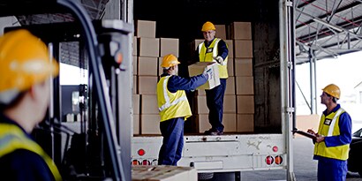 workers unloading boxes from a delivery truck
