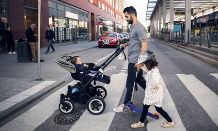 Adult and child crossing a road
