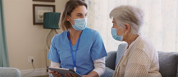 A nurse talking to a patient in an office