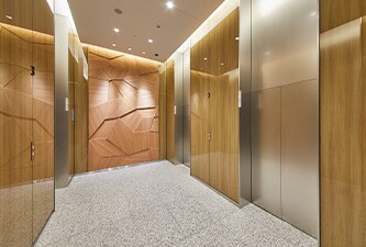 Elevator bay with wood grain 3M DI-NOC Glass Finish on walls
