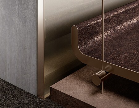 Close up of bench and wall finished with various metallic 3M surface finishes.
