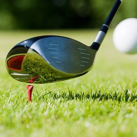 Learn about the transfer of energy through rigid adhesives and adhesive joints. Image of golf club striking ball.