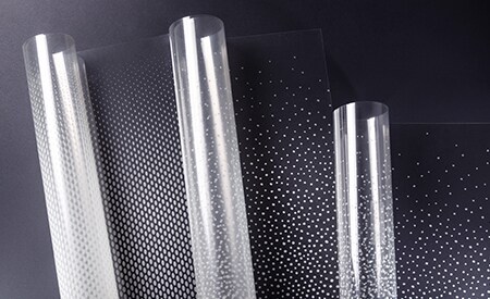 Three unspooling rolls of 3M FASARA glass finishes with dot gradation patterns
