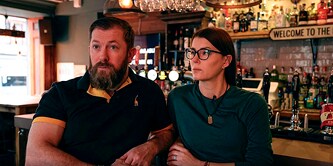 Two people in a bar
