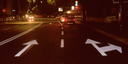 Car at a junction in the dark
