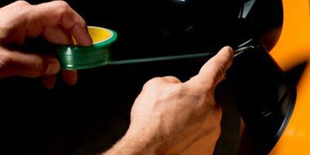 Man using knifeless tape
