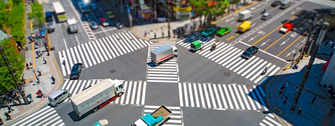 Ariel photograph of a large cross-road junction in a city
