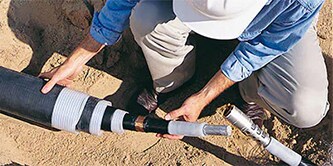 A worker is using 3M™ Cold Shrink technology for medium voltage splices/joints

