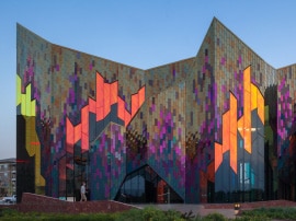 Exterior glass of the building features a colorful pattern created by 3M™ DICHROIC Glass Finishes.
