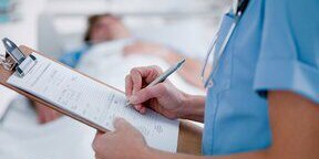 doctor writing on a clipboard

