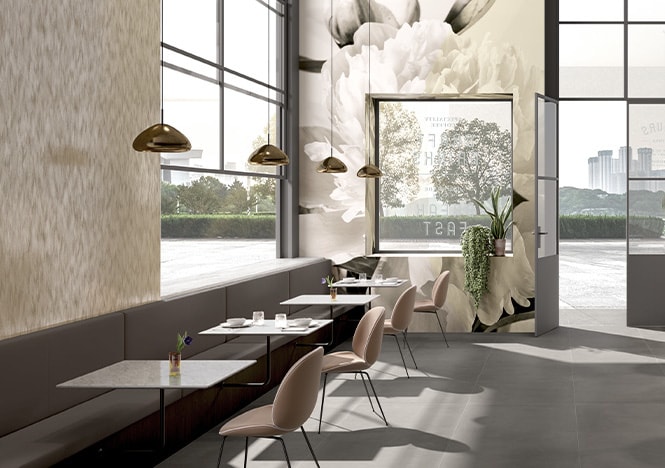 Cafe interior decorated with neutral tones and printed floral mural on graphic film covering walls.