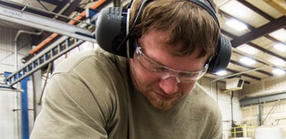 Man wearing PPE ear muffs for hearing protection
