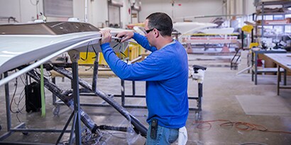 Image showing man working on bonding and sealing of a boat