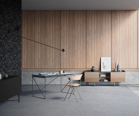 Interior of minimally decorated, modern room with walls finished with black marble, concrete, and medium wood 3M DI-NOC Architectural Finishes.
