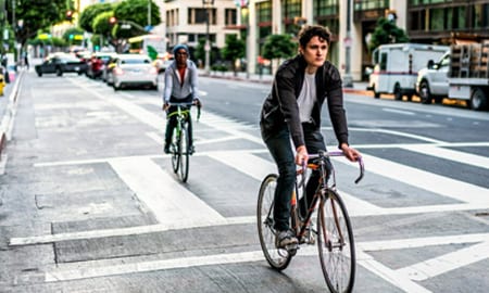 People cycling on a city road
