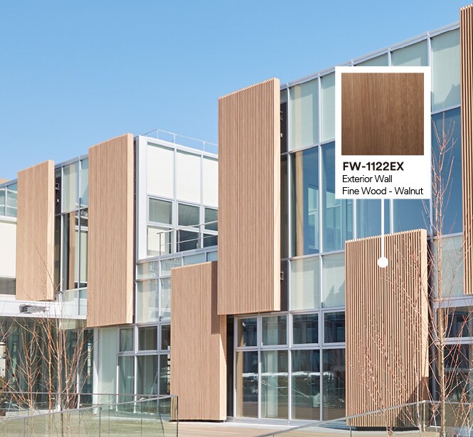 Exterior of building with glass and wood façade featuring product callout of Walnut DINOC Exterior film.