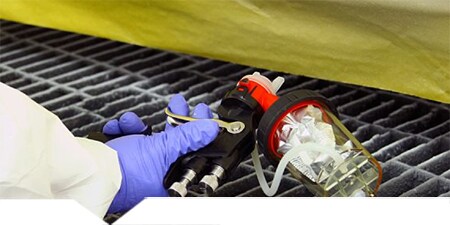 Technician using 3M Accuspray Gun to apply protective coating
