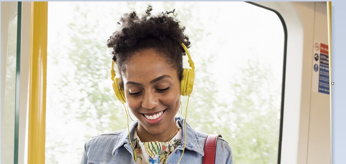 Passenger looking happy on a comfortable train car.
