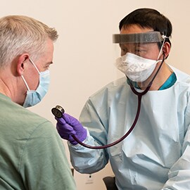 Patient and medical staff wearing N95 respirators