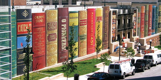 Exterior shot of library wrapped with graphic film printed to look like giant books lined up.
