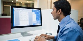 Businessman looking at data on a computer
