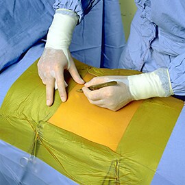 A surgeon making an incision