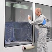 Man cleaning a window with a white cloth