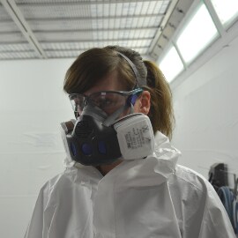 Person wearing personal protective equipment in paintshop