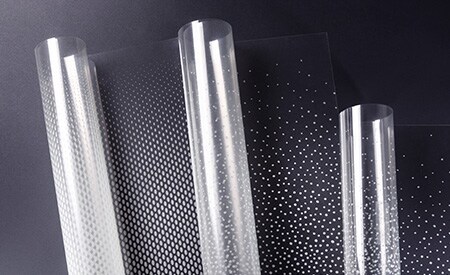 Three unspooling rolls of 3M FASARA glass finishes with dot gradation patterns
