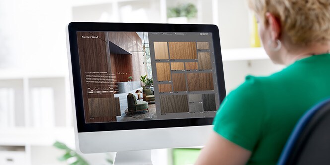 Image of woman using desktop computer to browse interactive catalog.
